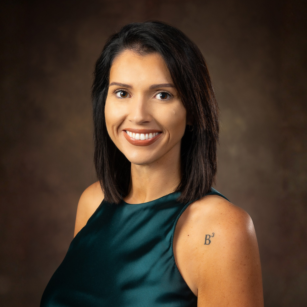young professional woman with dark hair and green dress