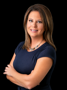 Woman on black background in navy dress